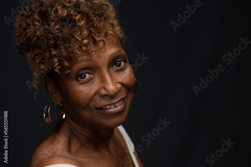 Closeup portrait of a beautiful retired elderly African American female  widow in her 70s with smiling expression and personality, one photo