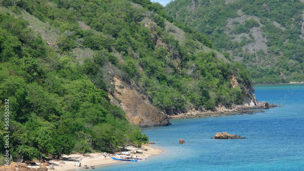 Tropical island views with turquoise ocean water and white sandy beaches in Labuan Bajo, Flores Island Indonesia Tropical island views with turquoise ocean water and white sandy beaches in Labuan Bajo, Flores Island Indonesia
