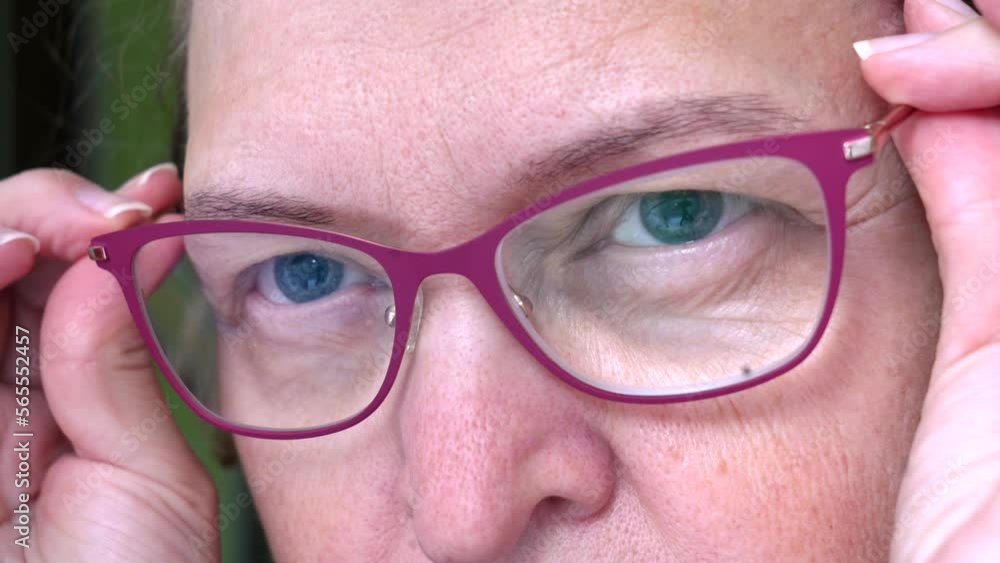 Middle-aged woman wearing glasses with pupils dilated of eyes, face woman in glasses, closeup Middle-aged woman wearing glasses with pupils dilated of eyes, face woman in glasses, closeup