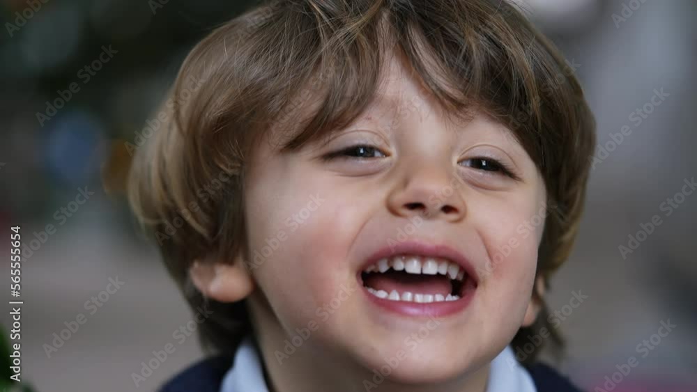 One cute small boy portrait face closeup smiling and laughing One cute small boy portrait face closeup smiling and laughing