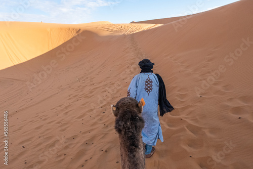 Camel driver in the desert dunes of Morocco.