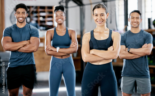 Fitness, portrait and woman coach with clients standing with crossed arms for confidence in the gym. Sports, collaboration and happy people after exercise, workout or training class in sport studio.
