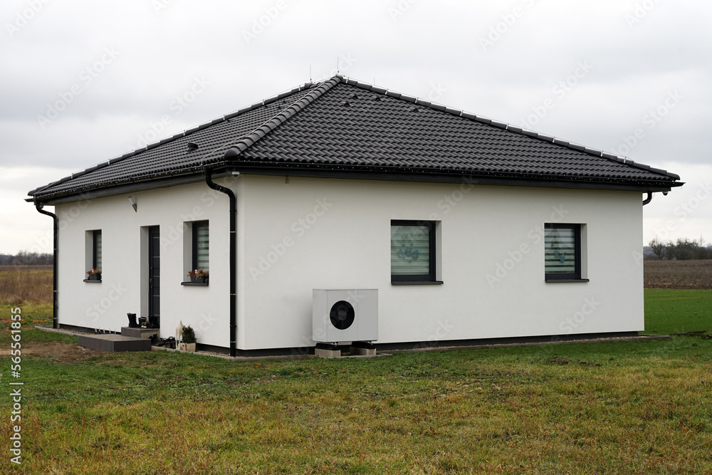 Heat pump outdoor unit in modern new house of future using green electric energy, efficient heat pump save money
