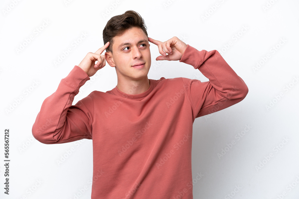 Young handsome Brazilian man isolated on white background having doubts and thinking Young handsome Brazilian man isolated on white background having doubts and thinking