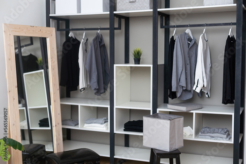 Modern wardrobe with stylish clothes in room interior © Angelov