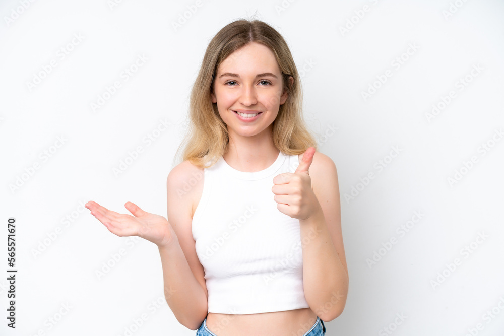 Blonde English young girl isolated on white background holding copyspace imaginary on the palm to insert an ad and with thumbs up Blonde English young girl isolated on white background holding copyspace imaginary on the palm to insert an ad and with thumbs up
