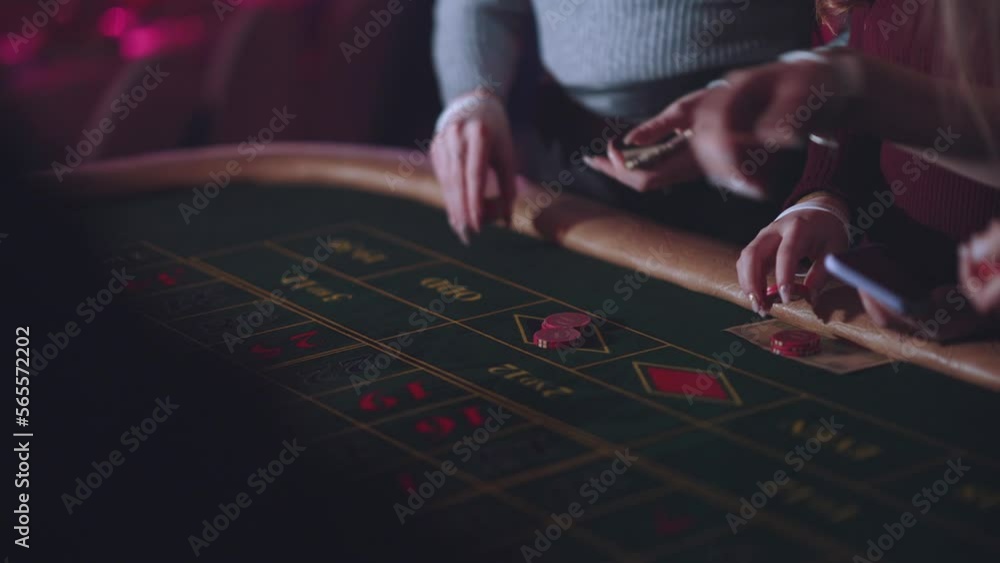 The croupier takes bets in the casino, bets in the casino close-up The croupier takes bets in the casino, bets in the casino close-up
