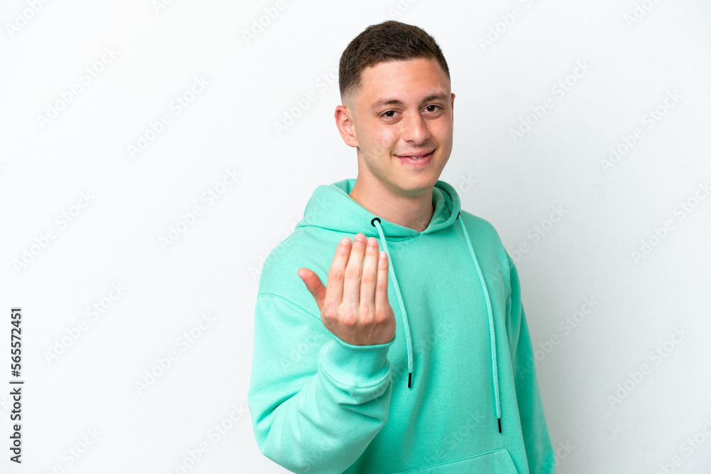 Young brazilian man isolated on white background inviting to come with hand. Happy that you came Young brazilian man isolated on white background inviting to come with hand. Happy that you came