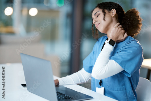 Obraz na plátně Doctor, laptop and neck pain at night in agony, stressed or burnout by desk at the hospital