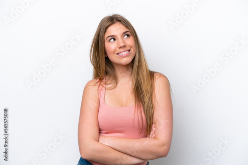 Young caucasian woman isolated on white bakcground looking up while smiling