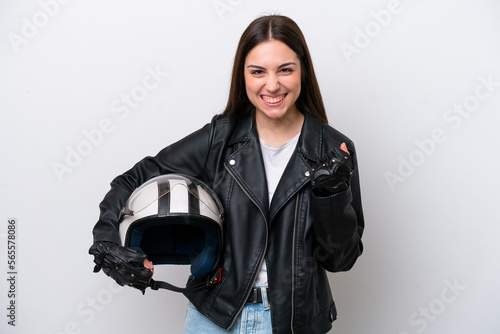 Young girl with a motorcycle helmet isolated on white background celebrating a victory in winner position