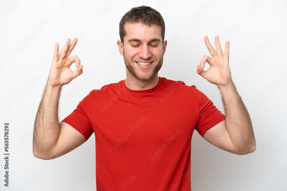 Young caucasian man isolated on white background in zen pose Young caucasian man isolated on white background in zen pose