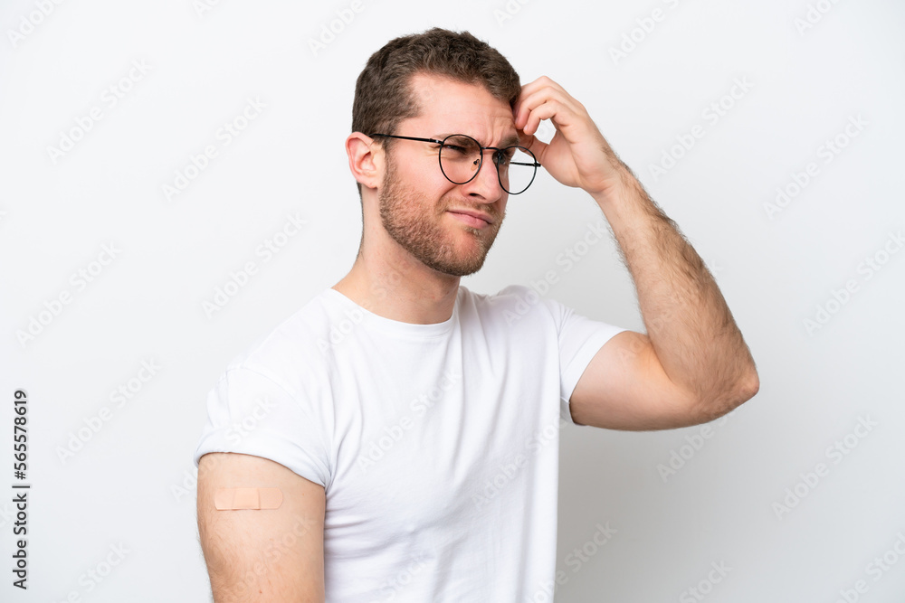 Young caucasian man wearing band aids isolated on white background having doubts and with confuse face expression Young caucasian man wearing band aids isolated on white background having doubts and with confuse face expression