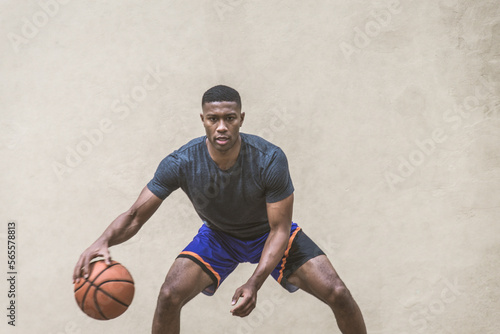 Athletic african american basketball player training on a court in New York - Sportive man playing basket outdoors
