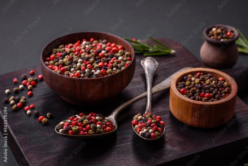 Spice allspice of different colors pink, white, green not ground in a wooden saucer Spice allspice of different colors pink, white, green not ground in a wooden saucer