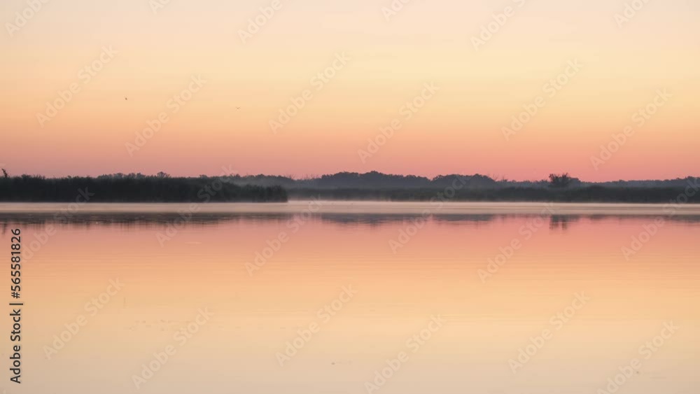 Sunrise. Nature background. Beautiful morning landscape. Foggy calm river with fog in golden sunlight on water surface in early morning. Concept of travel nature meditation relaxation lifestyle Sunrise. Nature background. Beautiful morning landscape. Foggy calm river with fog in golden sunlight on water surface in early morning. Concept of travel nature meditation relaxation lifestyle