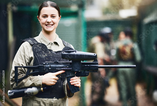Canvas Print Paintball, happy and portrait of woman with gun in safety uniform for outdoor shooting game with smile