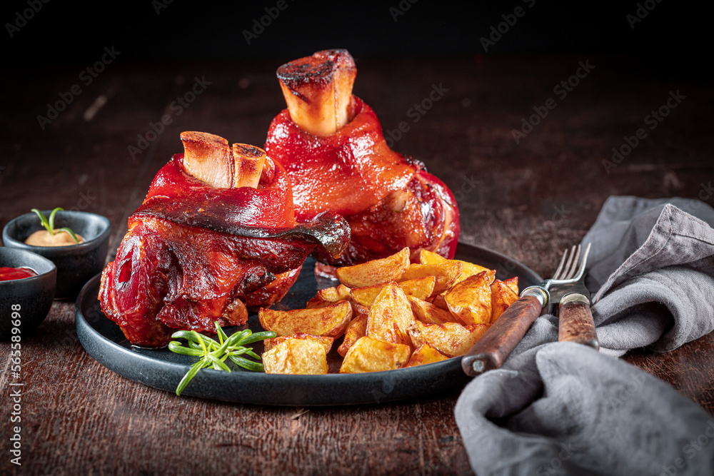 Homemade roasted pork knuckle served with mustard on plate. - obrazy, fototapety, plakaty 