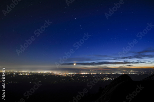 Aerial view of illuminated cityscape against sky during dusk