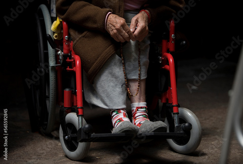 A woman prays the rosary in Our Lady of Guadalupe Home for the Elderly, Mexico City