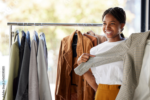 Shopping, clothes and black woman for choice, wardrobe inspiration or retail design ideas in thrift store or boutique. Happy customer, student or person service in fashion discount, sale or promotion
