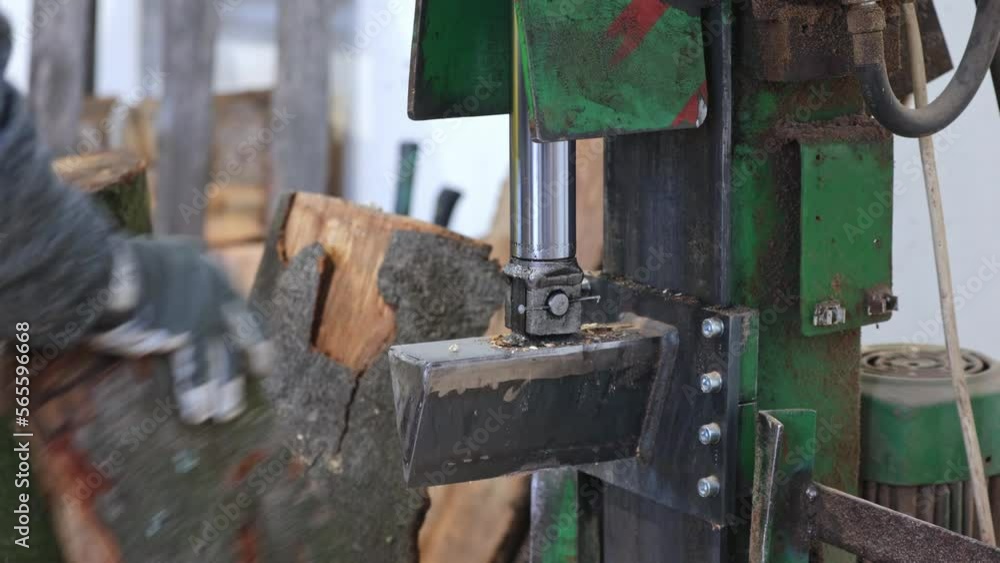 Woodworking production, worker using heavy saw to produce lumber planks or firewood, woodworking equipment concept Woodworking production, worker using heavy saw to produce lumber planks or firewood, woodworking equipment concept