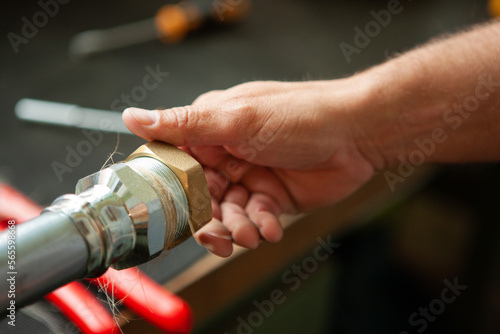 hands of a plumber sealing a pipe.