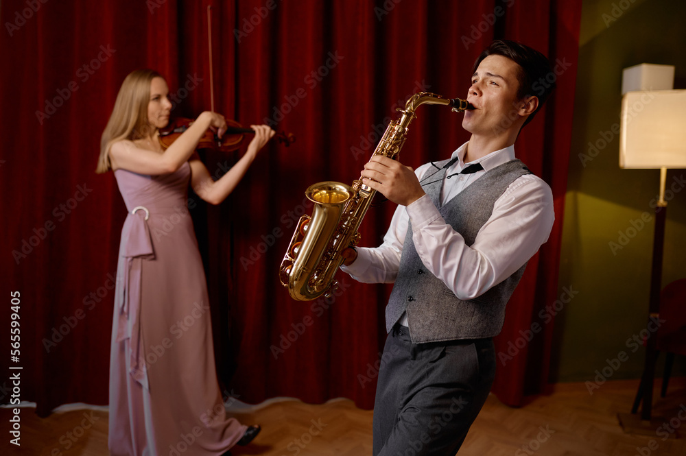 Naklejka premium Sax man and woman fiddler duet playing classical melody