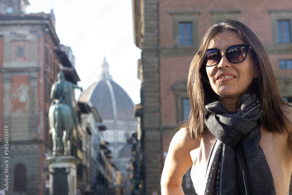 Portrait of woman smiling with sunglasses unfocused background at Florence, Italy. 50mm lens