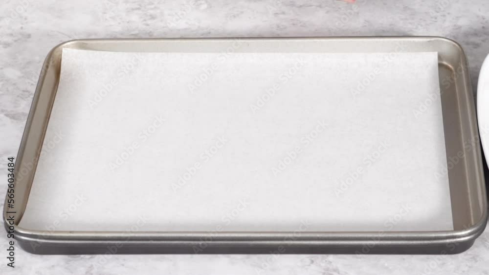 Step by step. Uncooked bacon strips on a baking sheet with white parchment paper. Step by step. Uncooked bacon strips on a baking sheet with white parchment paper.