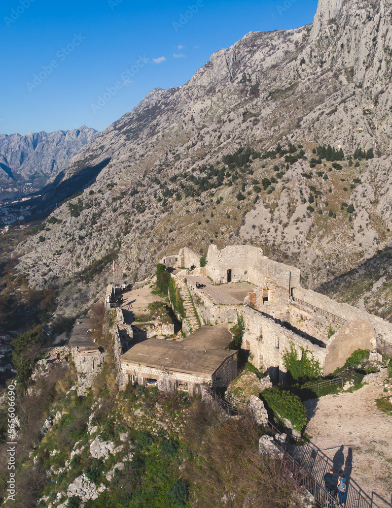 Kotor, Montenegro, process of climbing to the top of San Giovanni Fortress, Fort St. John, old medieval town, hiking on the Ladder of Kotor, sunny day with a blue sky and mount Lovcen and Orjen