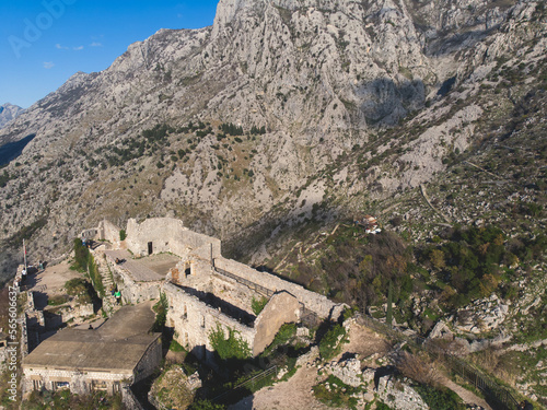 Kotor, Montenegro, process of climbing to the top of San Giovanni Fortress, Fort St. John, old medieval town, hiking on the Ladder of Kotor, sunny day with a blue sky and mount Lovcen and Orjen