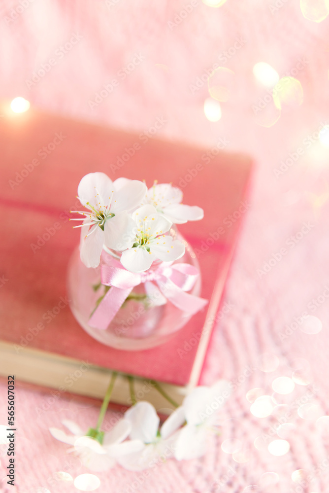 Spring background with a beautiful pink flowering branch. Pastel pink background, delicate flowers bloom.	
