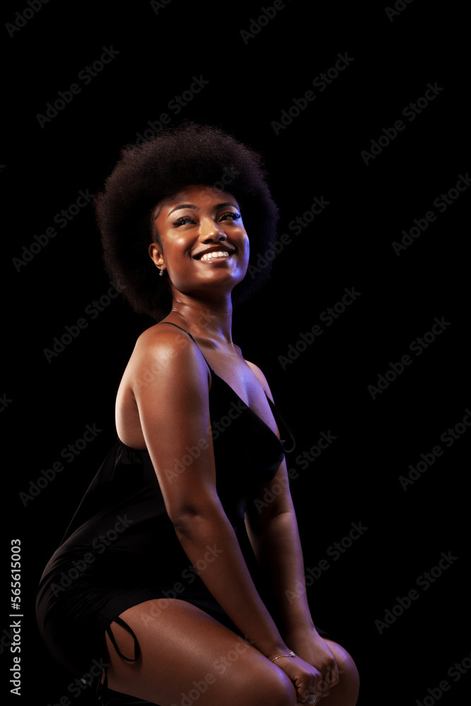 Studio portrait of elegant african american lady with curly hair afro hairstyle against black background. Happy girl smiling in black dress. Studio portrait of elegant african american lady with curly hair afro hairstyle against black background. Happy girl smiling in black dress.
