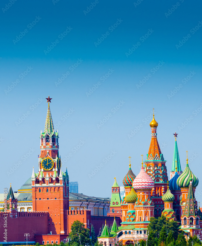 Fototapeta premium Spasskaya Tower of Moscow Kremlin and Cathedral of Vasily the Blessed (Saint Basil's Cathedral) on Red Square in sunny summer day. Moscow. Russia