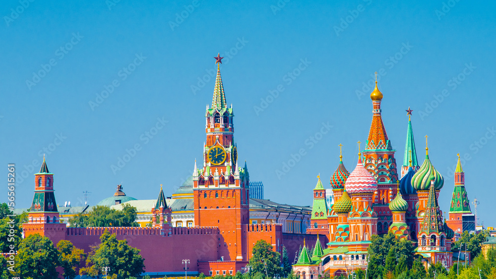Spasskaya Tower of Moscow Kremlin and Cathedral of Vasily the Blessed (Saint Basil's Cathedral) on Red Square in sunny summer day. Panoramic view. Moscow. Russia Spasskaya Tower of Moscow Kremlin and Cathedral of Vasily the Blessed (Saint Basil's Cathedral) on Red Square in sunny summer day. Panoramic view. Moscow. Russia