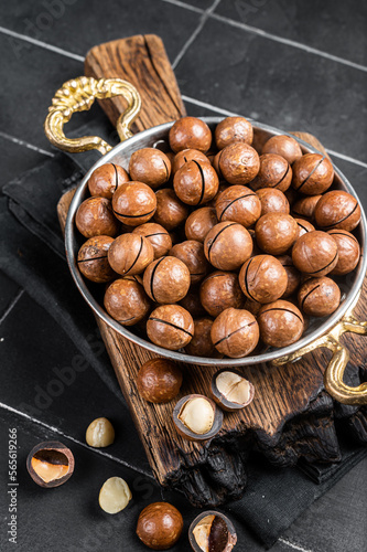 Macadamia nuts in a shell ready to eat. Black background. Top view