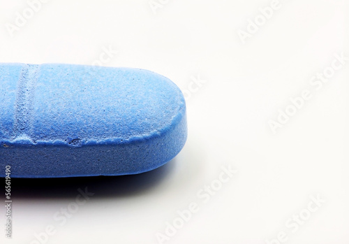 A blue pill or medicine on a white background