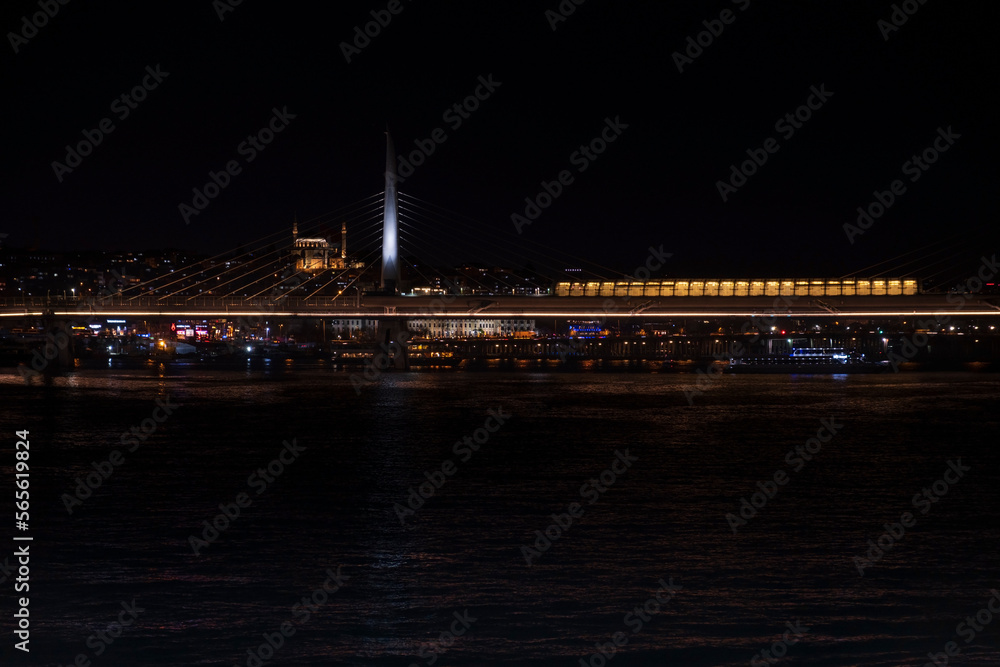 Night view of Halic Metro Bridge from Galata Bridge. Istanbul night landscapes. Istanbul night silhouette. Metro lines and bridges.
