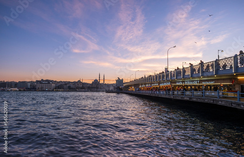 Karakoy, Istanbul, Turkey, 01.20.2023: People fishing at the Galata Bridge at sunset. Sunset in Istanbul. Istanbul cityscape. Galata Bridge, Golden Horn in Istanbul.