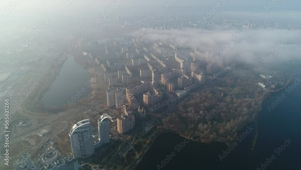 Obolonskaya embankment and Dnipro river. Apartment buildings, real estate. Natalka park. Obolon district in Kyiv city, Ukraine. Aerial. Fog