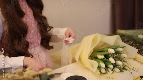 Young woman cuts off the limbs of flowers