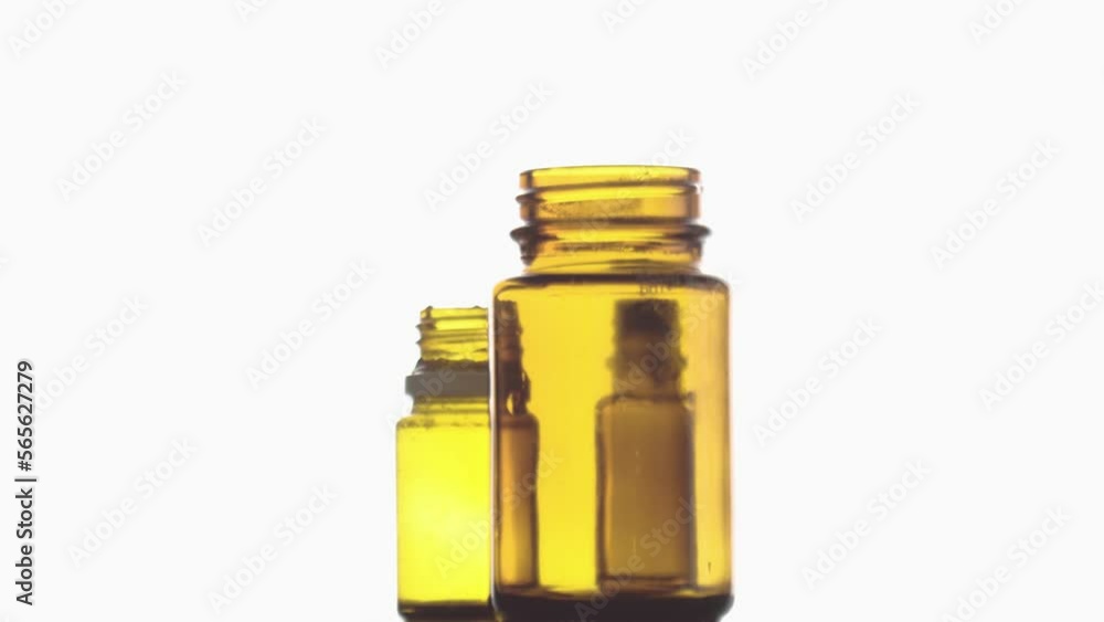 three empty medication glass bottles on rotating surface three empty medication glass bottles on rotating surface