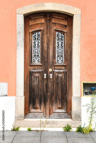 Old wooden door with wrought iron door knockers