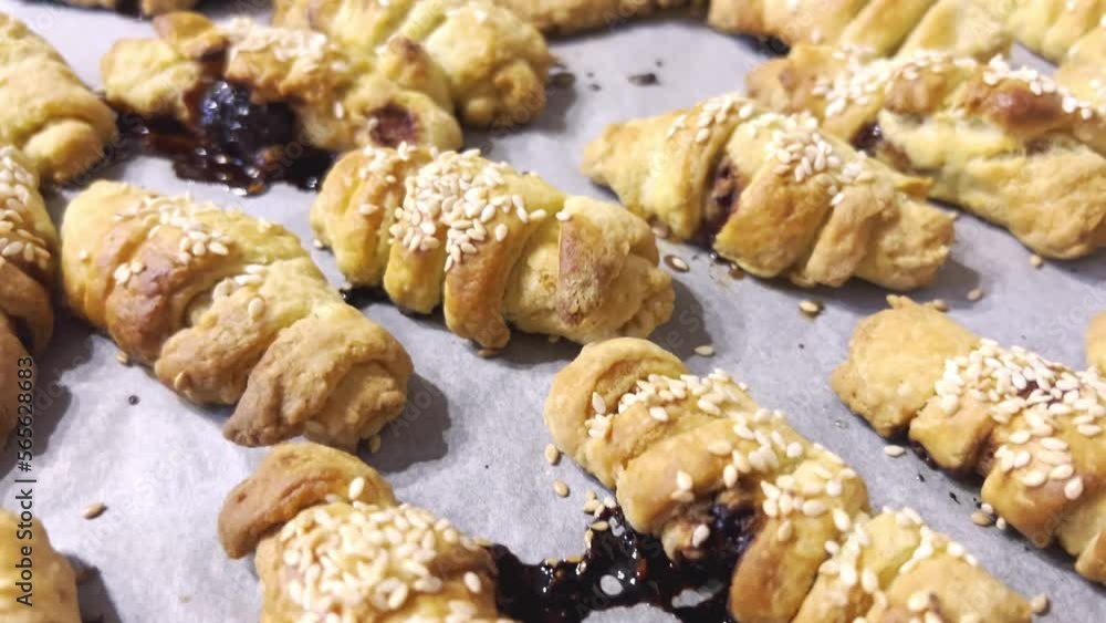 Freshly made homemade cookies lie on a baking sheet. Slow camera movement. Freshly made homemade cookies lie on a baking sheet. Slow camera movement.