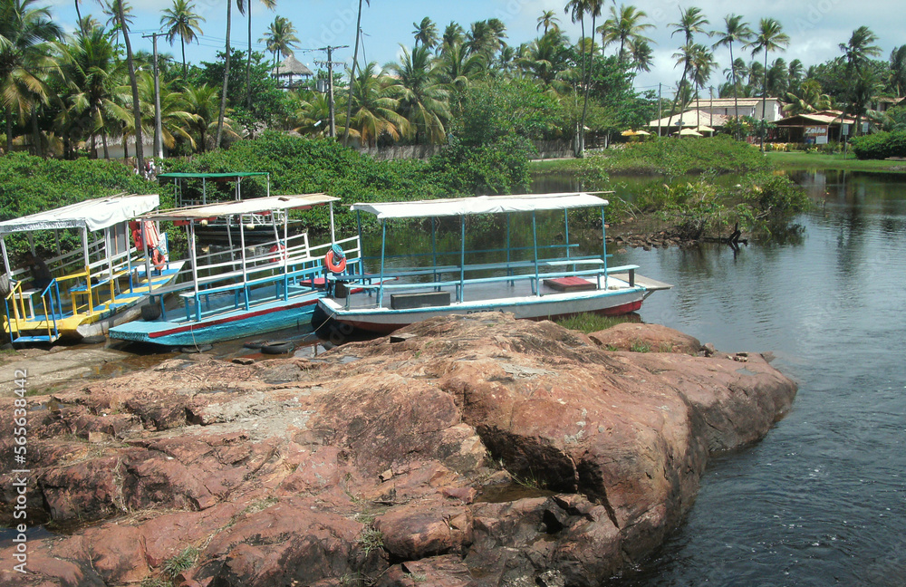 Naklejka premium boats on the river near the beach