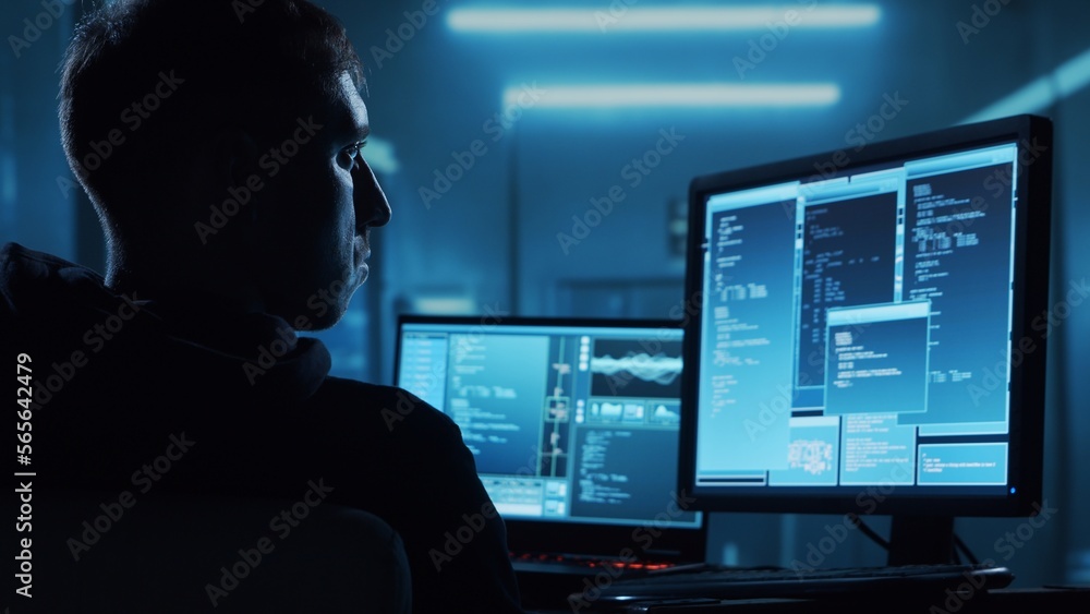 Computer Hacker in Hoodie. Obscured Dark Face. Concept of Hacker Attack, Virus Infected Software, Dark Web and Cyber Security. Computer Hacker in Hoodie. Obscured Dark Face. Concept of Hacker Attack, Virus Infected Software, Dark Web and Cyber Security.