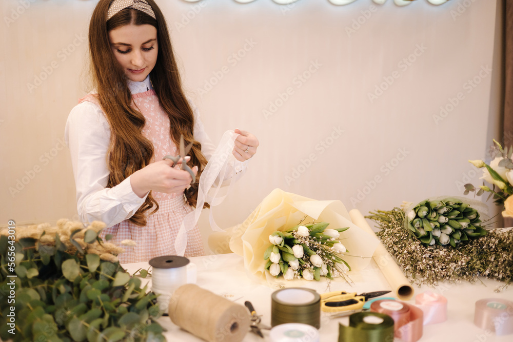 Female make spring bouquet. Gardener's in the flower shop make bouquet. Lifestyle flower shop. Beautiful flower composition Female make spring bouquet. Gardener's in the flower shop make bouquet. Lifestyle flower shop. Beautiful flower composition
