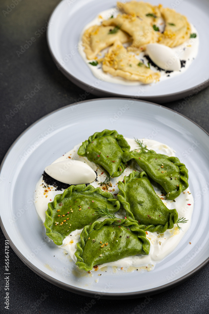 delicious Ukrainian dumplings with sauce on a plate.
delicious Ukrainian dumplings with sauce on a plate.