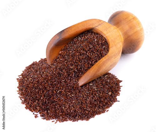 Psyllium seeds in wooden scoop, isolated on white background. Plantain. Plantago psyllium. photo